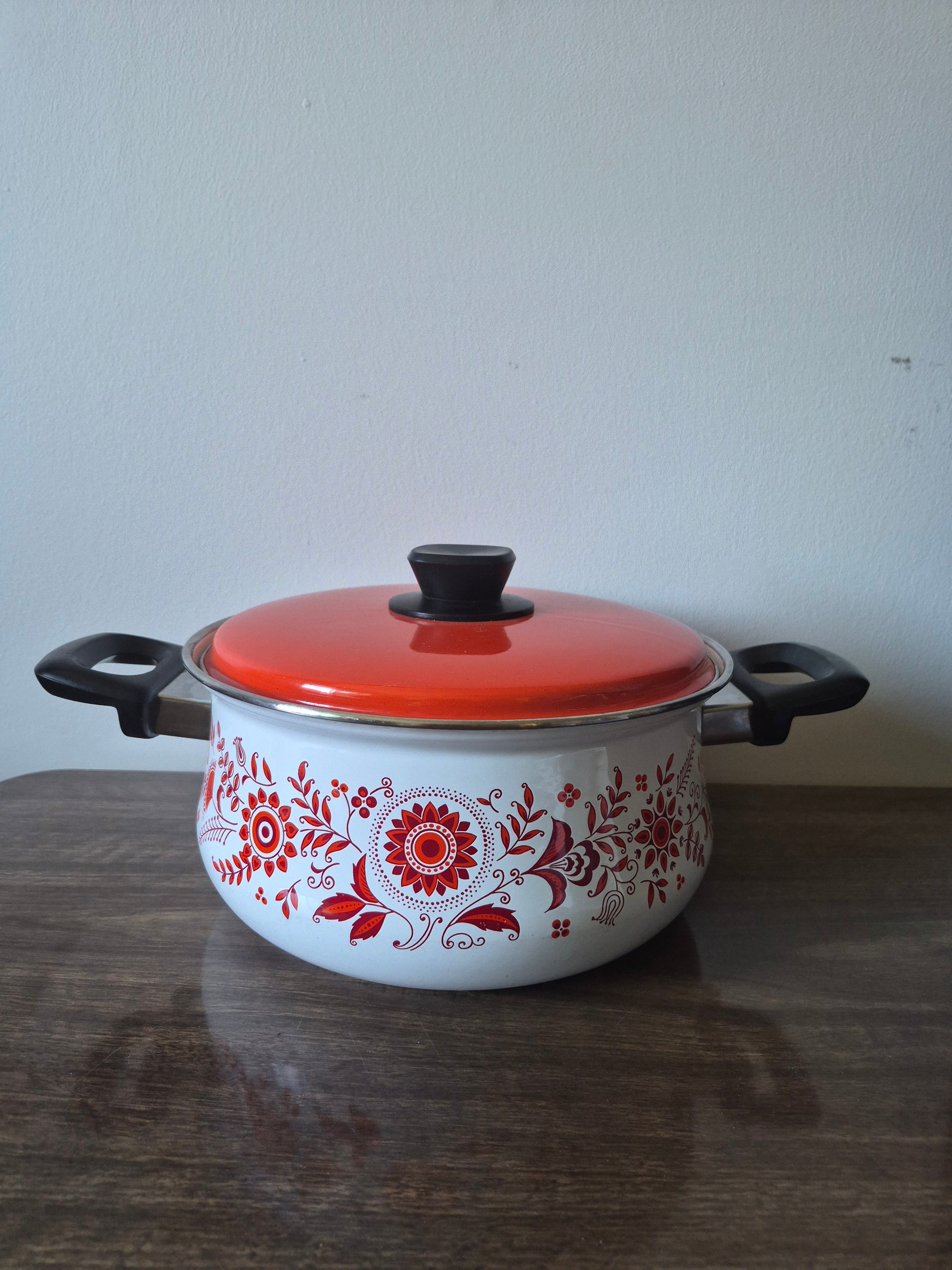 Ceramic pot with floral design on a white surface